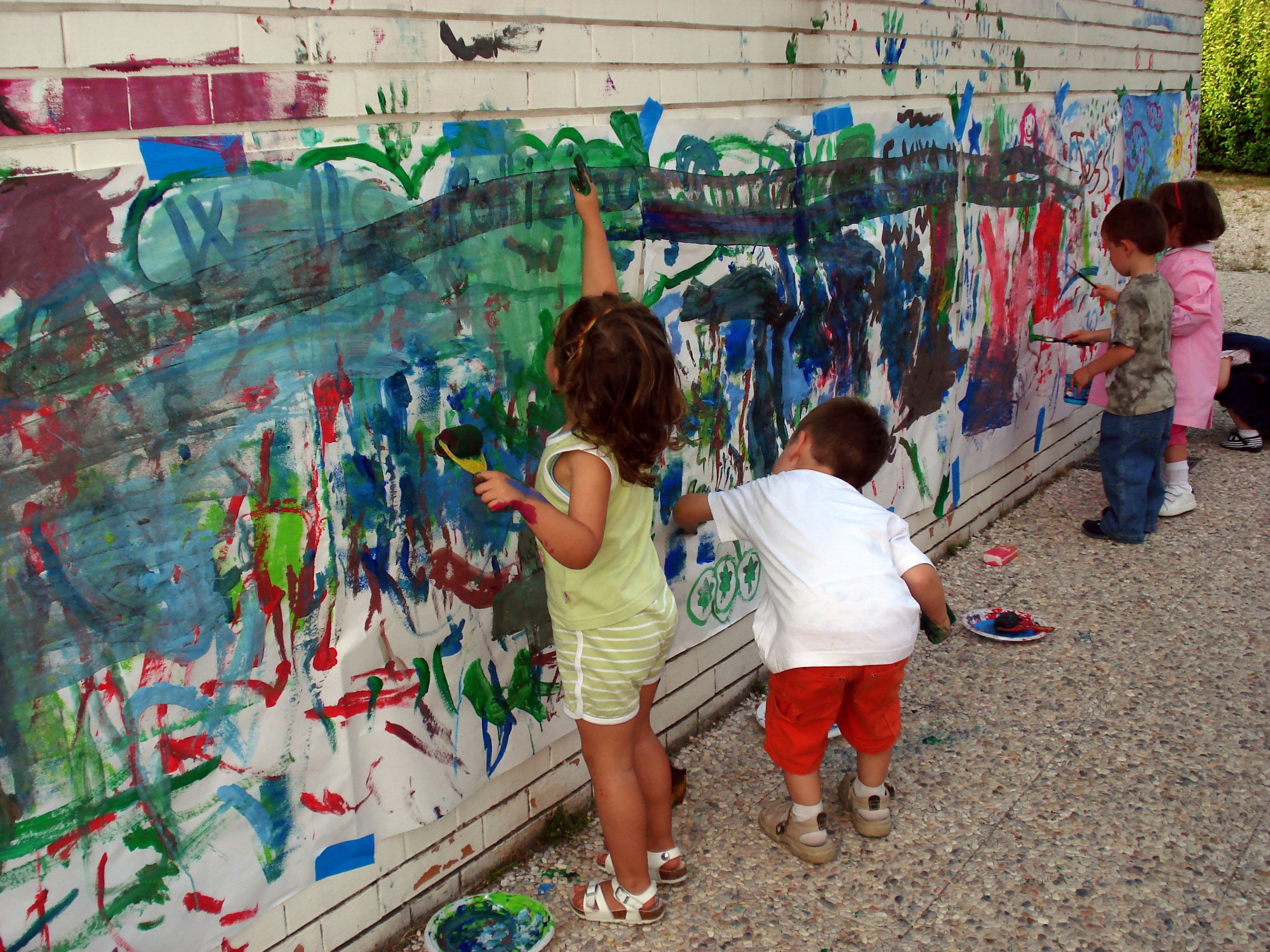 Children painting together at easels