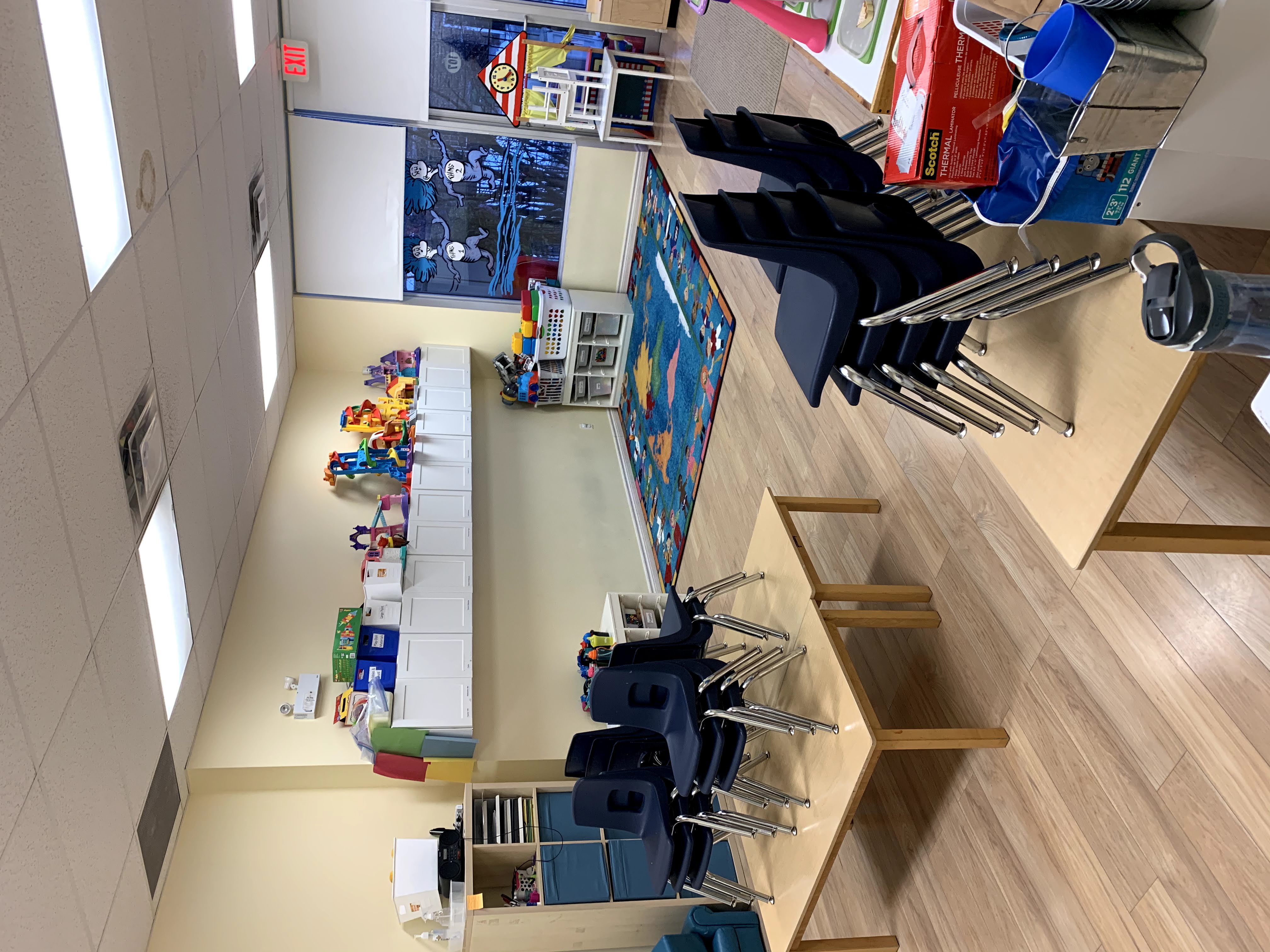 Teacher reading in a cozy classroom corner